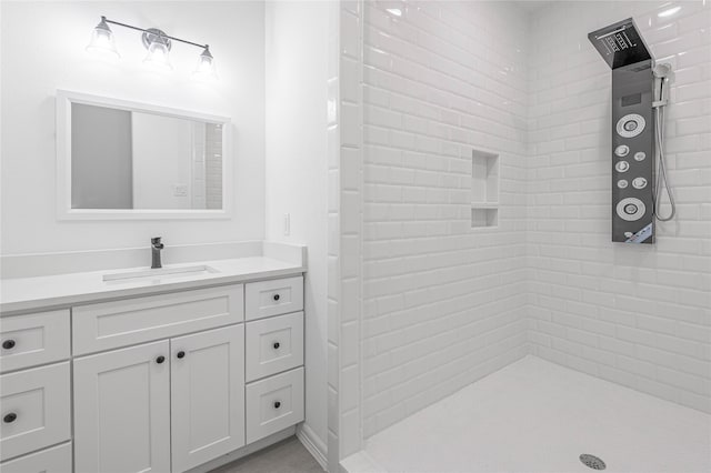 bathroom with vanity and tiled shower