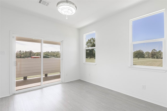 spare room with light hardwood / wood-style floors