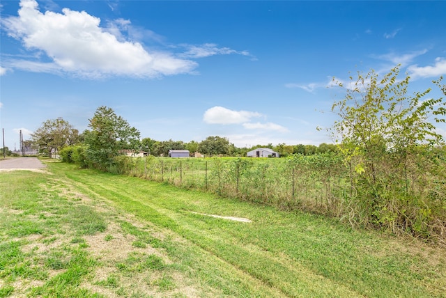 view of yard with a rural view