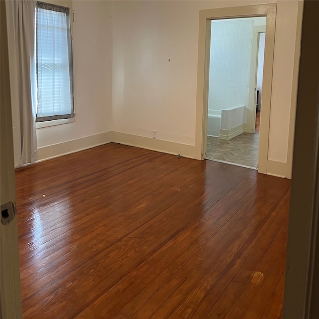 spare room with dark wood-type flooring