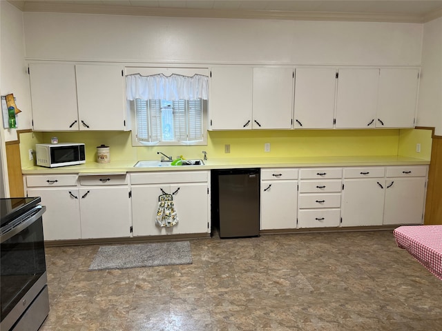 kitchen with black dishwasher, white cabinets, sink, and light tile floors