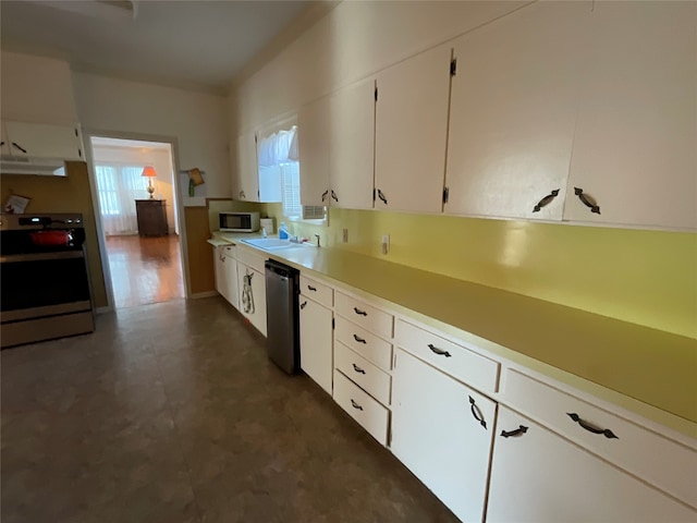 kitchen with white cabinets, appliances with stainless steel finishes, and sink