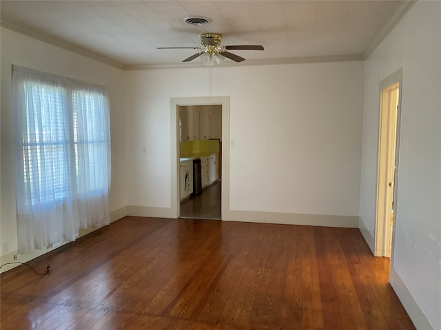 spare room with ceiling fan, dark hardwood / wood-style flooring, and ornamental molding