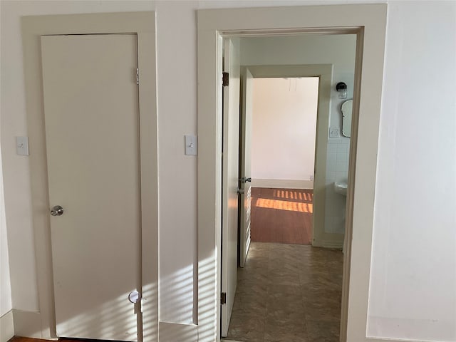 corridor with dark tile flooring