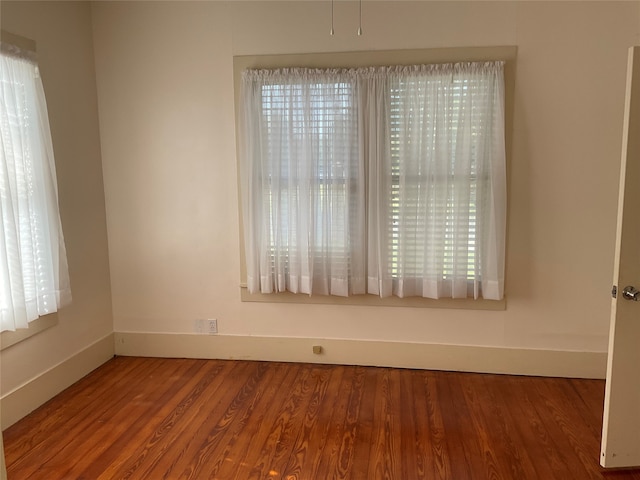 empty room featuring hardwood / wood-style floors and a wealth of natural light
