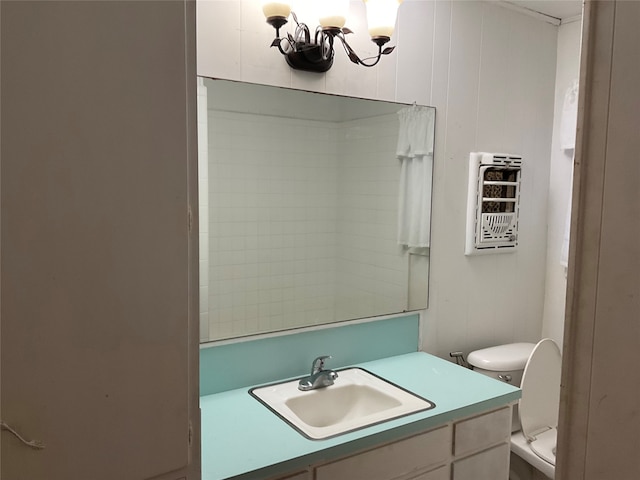 bathroom featuring vanity, a chandelier, and toilet