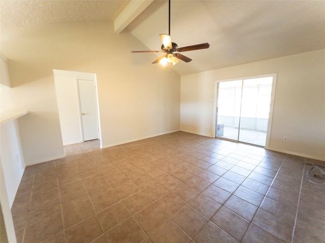 spare room with ceiling fan, lofted ceiling with beams, and dark tile floors