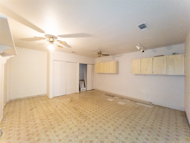 basement with light tile floors and ceiling fan