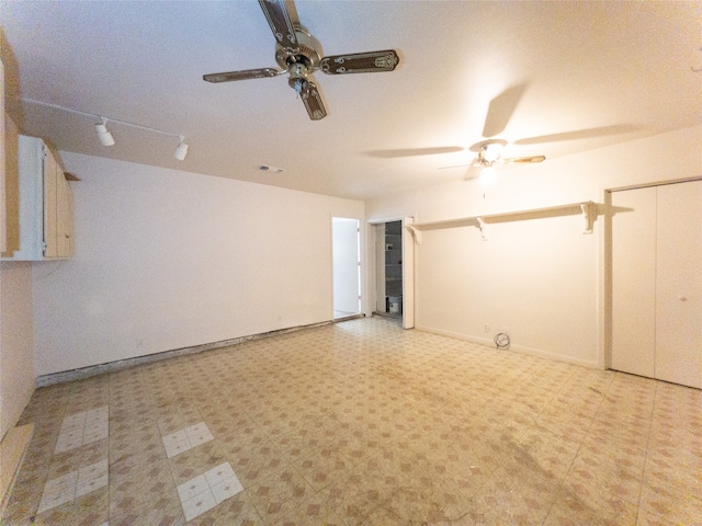 basement with ceiling fan and light tile floors