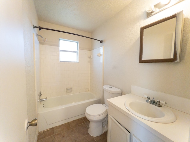 full bathroom featuring toilet, vanity, a textured ceiling, tiled shower / bath, and tile flooring