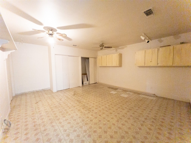 basement featuring ceiling fan and light tile flooring