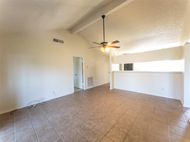 tiled empty room with ceiling fan, beamed ceiling, and high vaulted ceiling