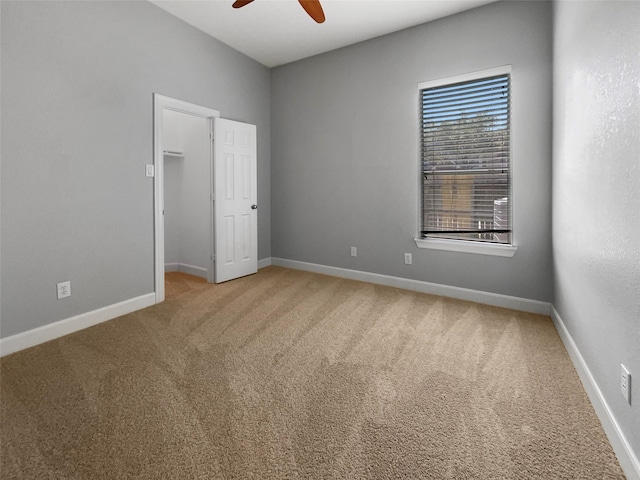 carpeted empty room with ceiling fan