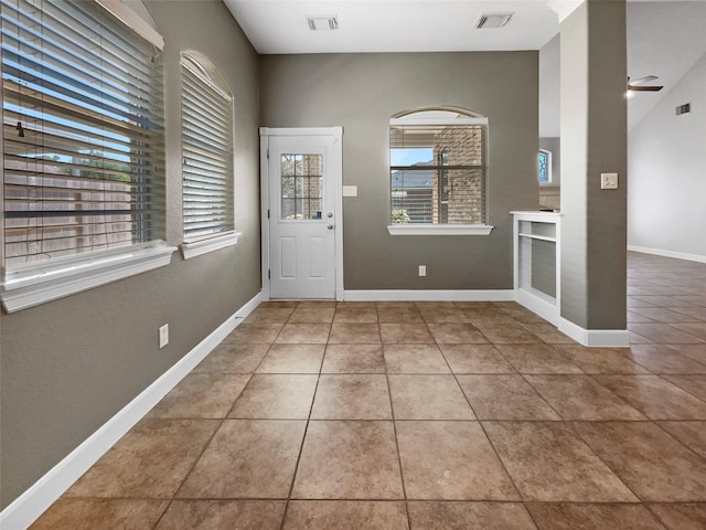 foyer entrance with tile patterned flooring and ceiling fan