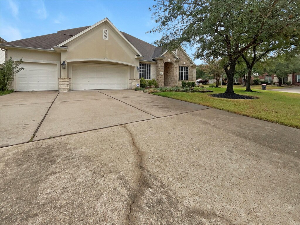 14206 Chapel Hollow Ln, Cypress, TX 77429 - ranch-style home featuring a garage and a front lawn