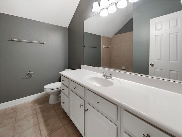 bathroom featuring tile patterned floors, toilet, vaulted ceiling, and vanity