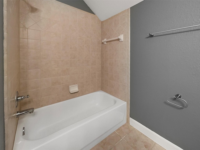 bathroom featuring tile patterned flooring and tiled shower / bath