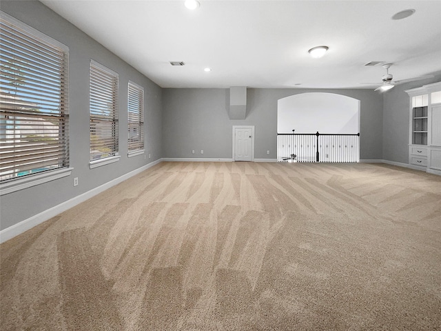 empty room featuring light carpet and ceiling fan