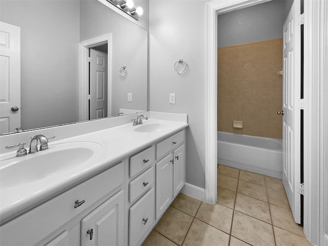 bathroom with tiled shower / bath, vanity, and tile patterned flooring