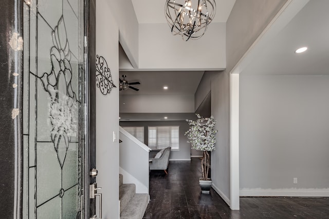 foyer featuring dark hardwood / wood-style floors and ceiling fan with notable chandelier