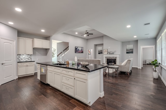 kitchen featuring a kitchen island, dark hardwood / wood-style floors, ceiling fan, white cabinetry, and dishwasher