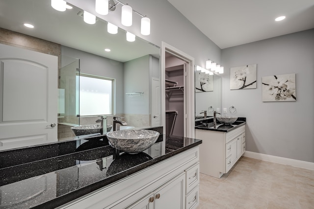 bathroom featuring tile floors and double vanity