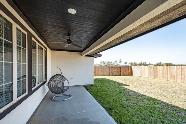 view of yard with ceiling fan and a patio