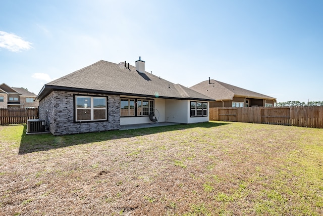 rear view of house featuring a lawn, a patio area, and central air condition unit