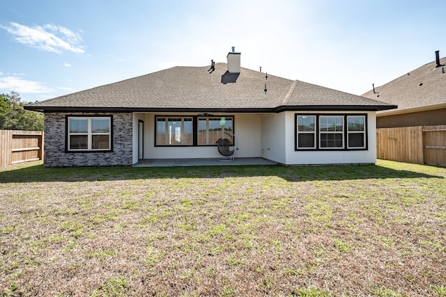 back of house featuring a patio area and a yard