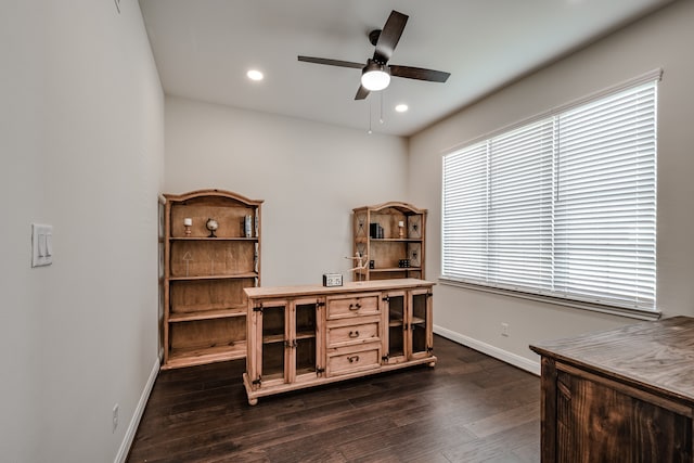 home office featuring dark hardwood / wood-style floors and ceiling fan