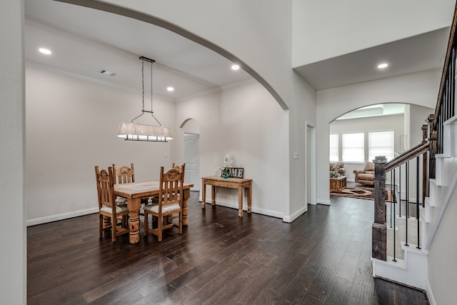 dining room featuring dark hardwood / wood-style floors, ornamental molding, and a chandelier