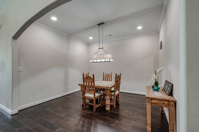 dining space featuring dark hardwood / wood-style flooring and ornamental molding