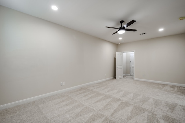 empty room featuring ceiling fan and light colored carpet