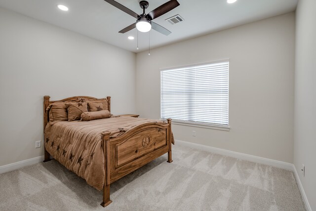 bedroom with light colored carpet and ceiling fan