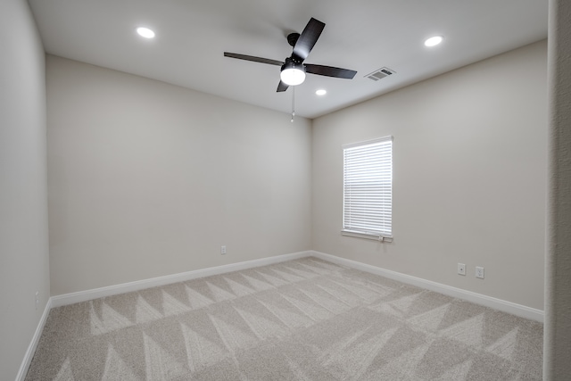 carpeted empty room featuring ceiling fan