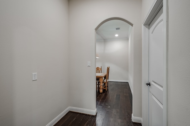 hall with crown molding and dark hardwood / wood-style floors