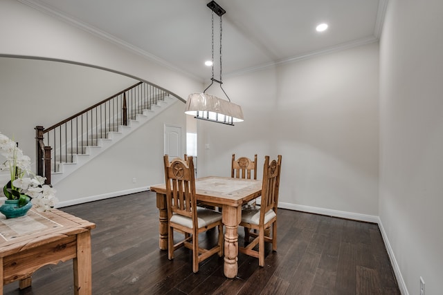 dining room with crown molding and dark hardwood / wood-style floors