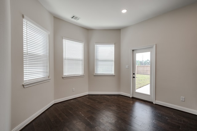 spare room with dark hardwood / wood-style floors