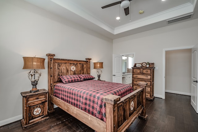 bedroom with dark hardwood / wood-style flooring, ceiling fan, and a raised ceiling