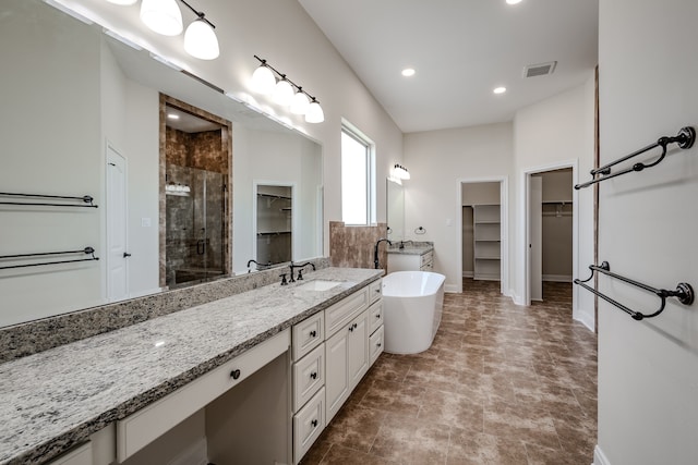 bathroom with tile flooring, plus walk in shower, and vanity