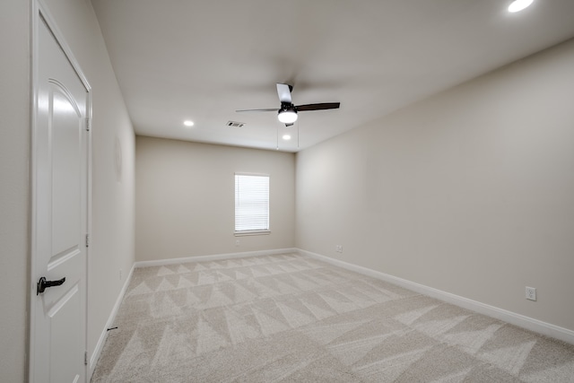 empty room featuring light colored carpet and ceiling fan