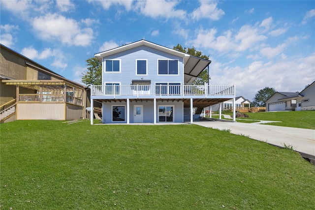 back of house with a deck, a yard, and a garage