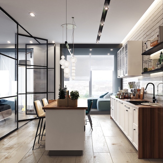 kitchen featuring a sink, open shelves, white cabinets, and expansive windows