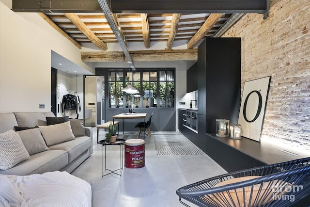 living area with beamed ceiling and finished concrete flooring