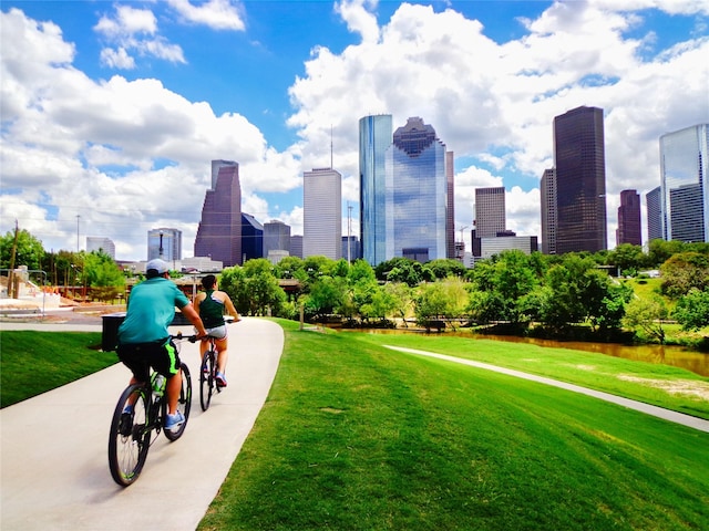 surrounding community with a city view and a yard