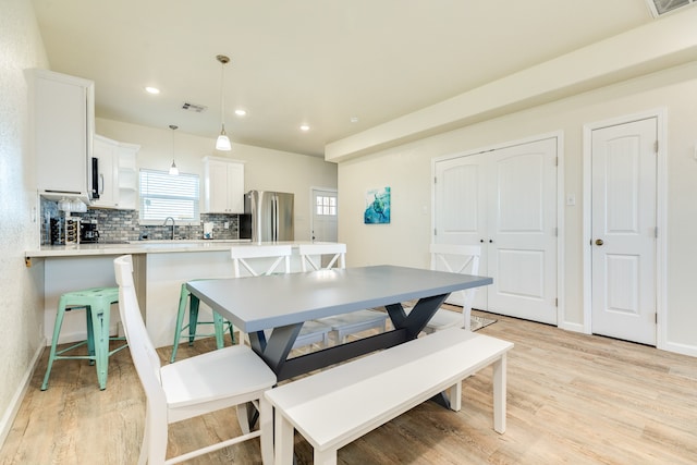 dining area featuring light hardwood / wood-style flooring and sink