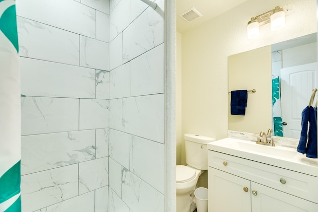 bathroom with large vanity and toilet