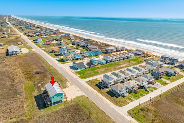 drone / aerial view with a water view and a view of the beach