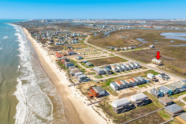 aerial view with a water view and a view of the beach