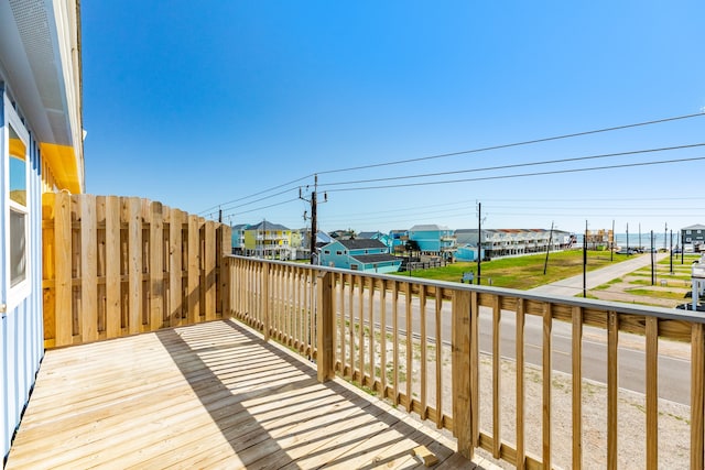 wooden terrace with a lawn